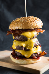 Big cheeseburger on a dark background