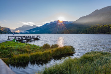 Naklejka na ściany i meble sunrise in the mountains on the lake