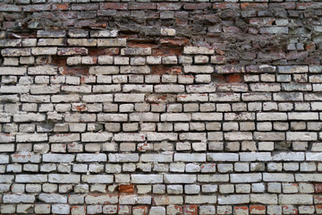 Ruined brick wall. Surface weathered by time