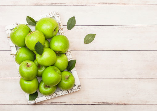 Fresh green healthy organic apples in vintage box on wooden background