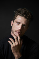 Blue eyed guy in black studio, portrait