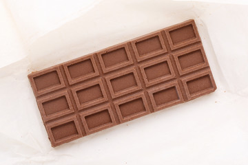 Artisan chocolate bar on white. Raw vegan handmade chocolate.