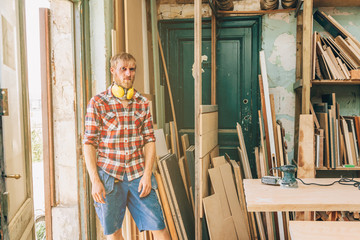 Fototapeta na wymiar portrait of a self confident carpenter in his workshop