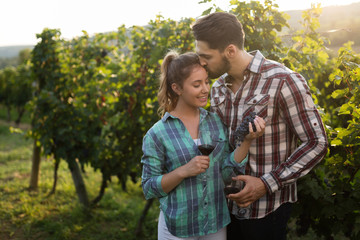 Couple in love working at winemaker vineyard