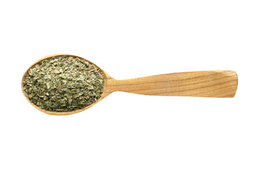 dried marjoram in wooden spoon isolated on white background. spice for cooking food, top view.