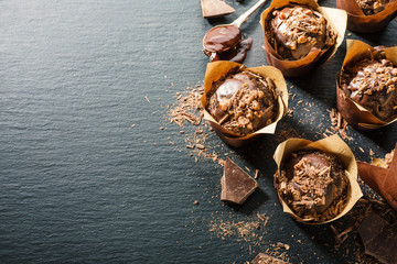 Chcolate muffins on dark table