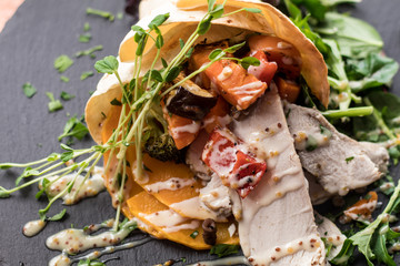 chicken and vegetable wrap on slate plate