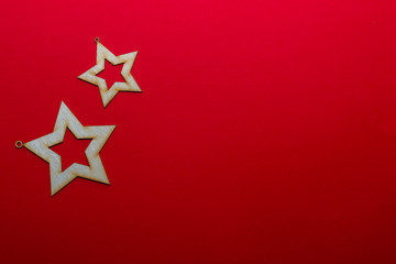 Christmas wooden toy of stars on a red background