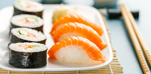 Sushi served on plate on blue table