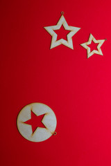 Christmas wooden toy of stars on a red background
