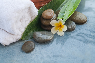 Tropical flower and spa objects for massage and relax on blue table background