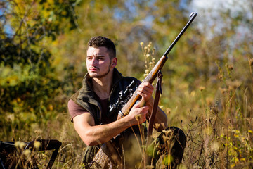 Man hunting wait for animal. Hunting strategy or method for locating targeting and killing targeted animal. Hunting skills and strategy. Hunter with rifle ready to hunting nature background