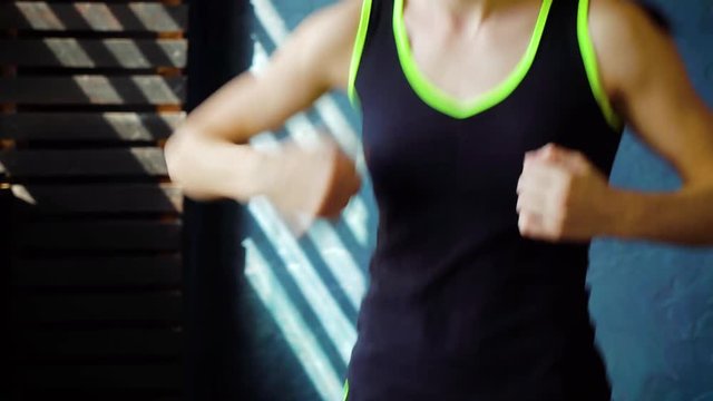 fit white female stretching arm muscles at gym. Young fitness woman warms up for workout. Wellness, healthy lifestyle, cardio workout concept