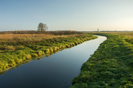 A quiet river through a meadow