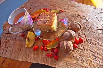 Breakfast, vegan food. Cake with nuts and a cup of tea with fresh rose hips.