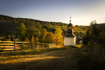 Beautiful evening morning chapel church in Krkonoše national park with mountains at sunrise at sunset