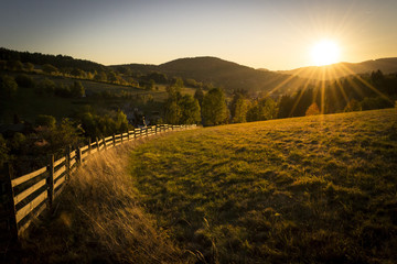 Beautiful evening morning country meadow in Krkonoše national park with mountains at sunrise at...
