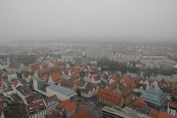 Fototapeta premium Cloudy Ulm city and Danube river view from the tallest Cathedral