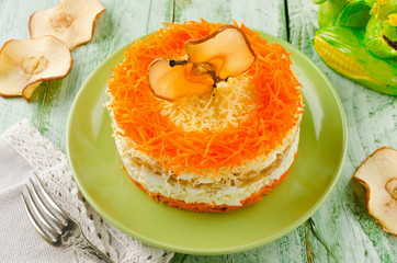 Layered salad with carrots, egg, cheese and apple