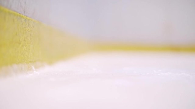 The puck bumps into into the enclosure wall and bounces away