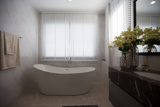 Minimal style bathroom clean and comfortable,towel,houseplant.
