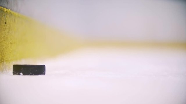 The puck slowly rolls up to the camera and stops. Close up