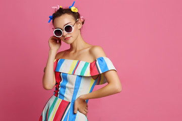 Fashion cool girl posing on pink background.