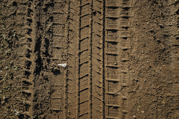 Wheel tracks on the soil. Tire tracks on the ground. Soil texture background. Ground. Soil closeup...