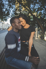 Obraz premium Lovely and cool mixed races couple in the park. Latino woman and african american man who are in love. Relationship. 