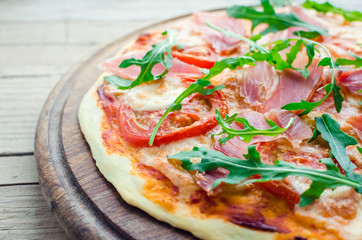 Italian pizza with prosciutto and arugula