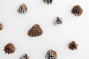 Christmas pattern made of christmas pine cones on white background. Creative flat lay, Creative flat lay, top view design