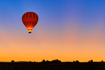 Hot air balloon in the sky during sunrise in Cappadocia