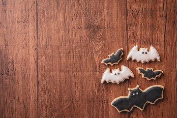 Fresh delicious homemade decorated halloween cookies sweets on dark wooden background, concept of halloween party, copy space(text space), top view, blank for text.