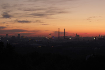 Fototapeta na wymiar Urban industrial silhouette photo of Moscow at beautiful orange sunset 