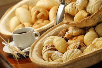 Sweet bread basket with cappuccino coffee.