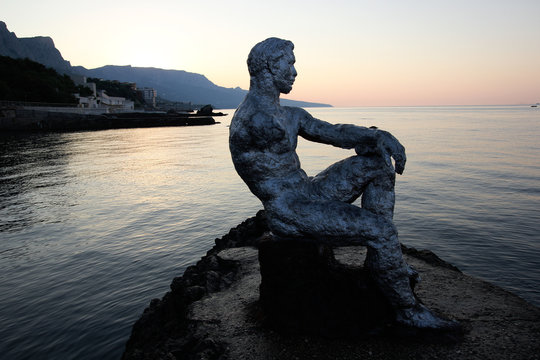 Iron statue of man watching at the Black sea in Foros, Crimea.