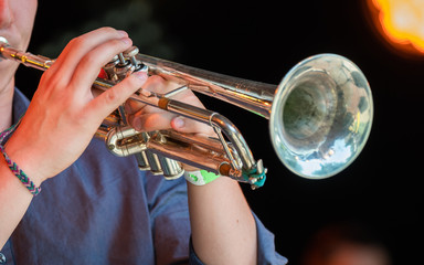 Musician playing trumpet at live concert on the stage