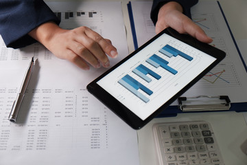 Women working in office. financial analysis with charts on pad for business, accounting, insurance...