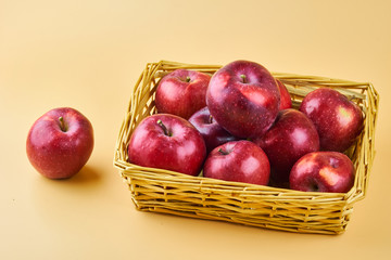 Tasty red apples in basket close up