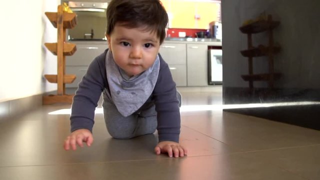 Adorable baby boy funny crawls in the floor