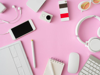 top view of office desk workspace with smartphone, notebook, graphic tablet, keyboard and mouse on pink color background, graphic designer, Creative Designer concept.