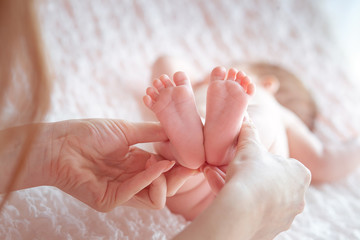 Baby legs in mother's hands