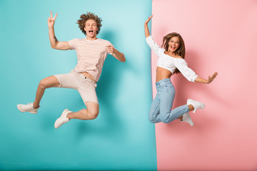 Full length of excited young couple standing