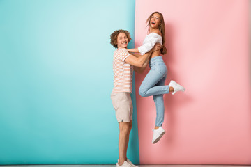 Full length of smiling young couple