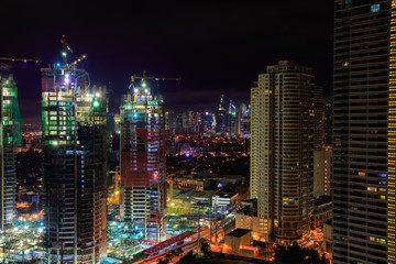 Fototapeta na wymiar Manila at night. Buildings and cranes. Long Exposure.