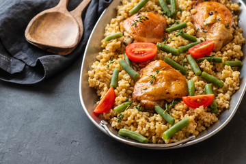 Grilled chicken thighs with bulgur, asparagus beans and tomatoes. Delicious lunch.