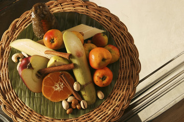 Basket with orange, apple, sugar cane, tejocote, tangerine, cinnamon, pear, and piloncillo to...