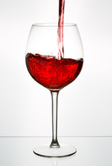 Beautiful splash of red wine in a glass