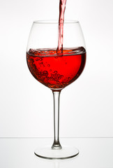 Beautiful splash of red wine in a glass