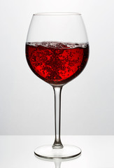 Beautiful splash of red wine in a glass